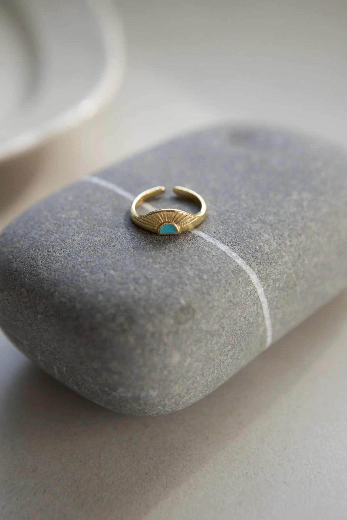 Greek ethnic boho ring in gold-tone metal with a turquoise accent and engraved rising sun fan detail