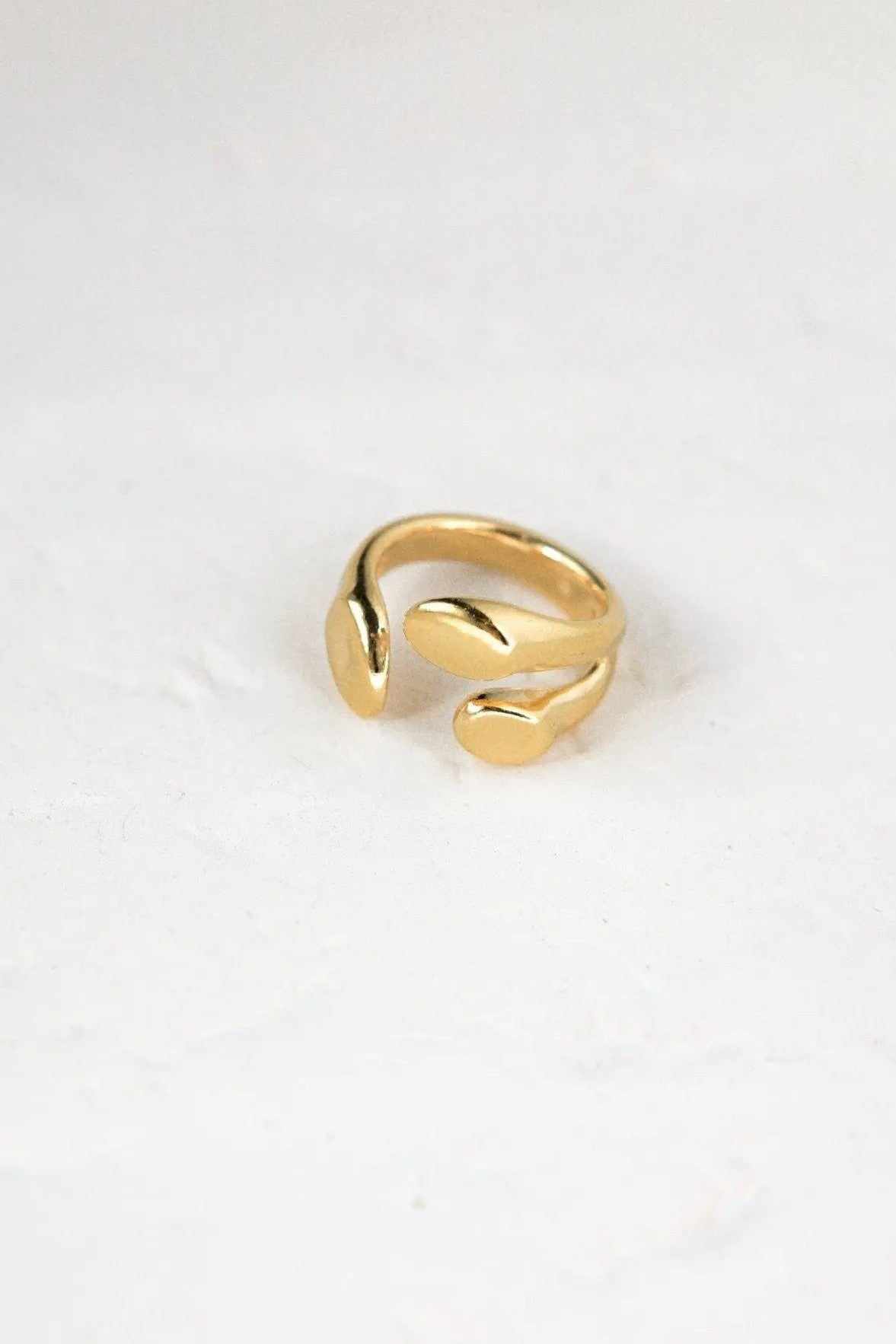 Greek Olive leaf ring in polished gold tone, with a smooth open adjustable band and sculpted leaf-shaped ends