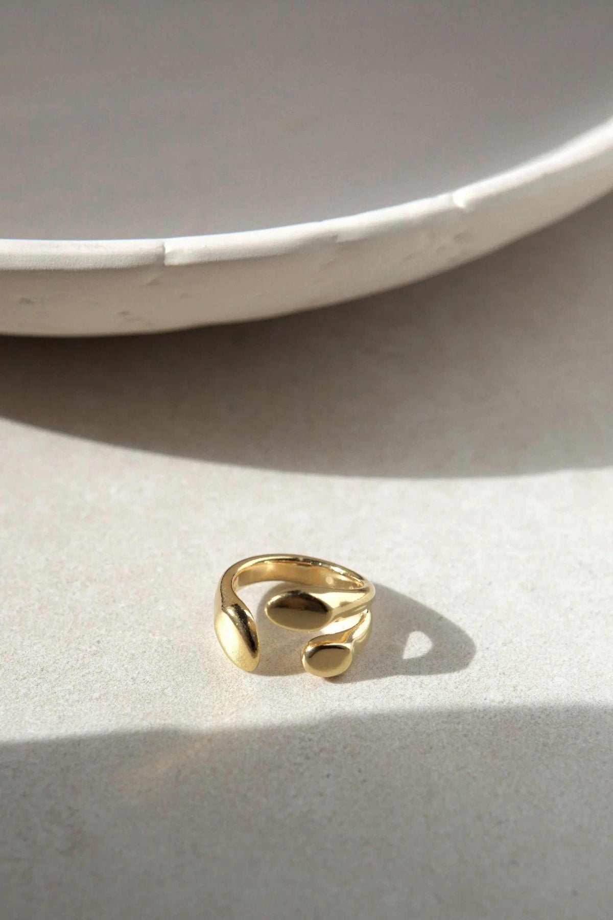 Greek Olive leaf ring in polished gold-tone metal, featuring a sculptural open design with rounded leaf-like forms