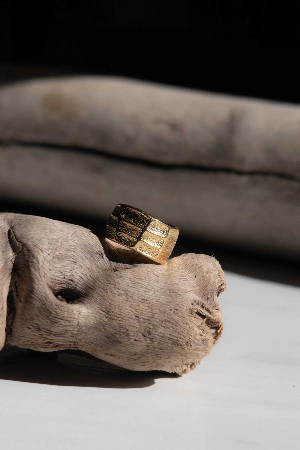 Greek wide ring in gold-tone metal with a broad band, textured panels and an open adjustable design