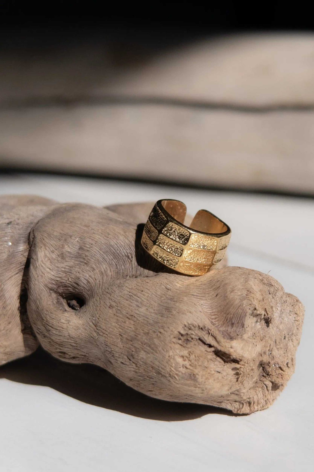 Greek wide ring in gold-tone metal with textured engraved bands, a broad adjustable open wrap design and dark recessed details