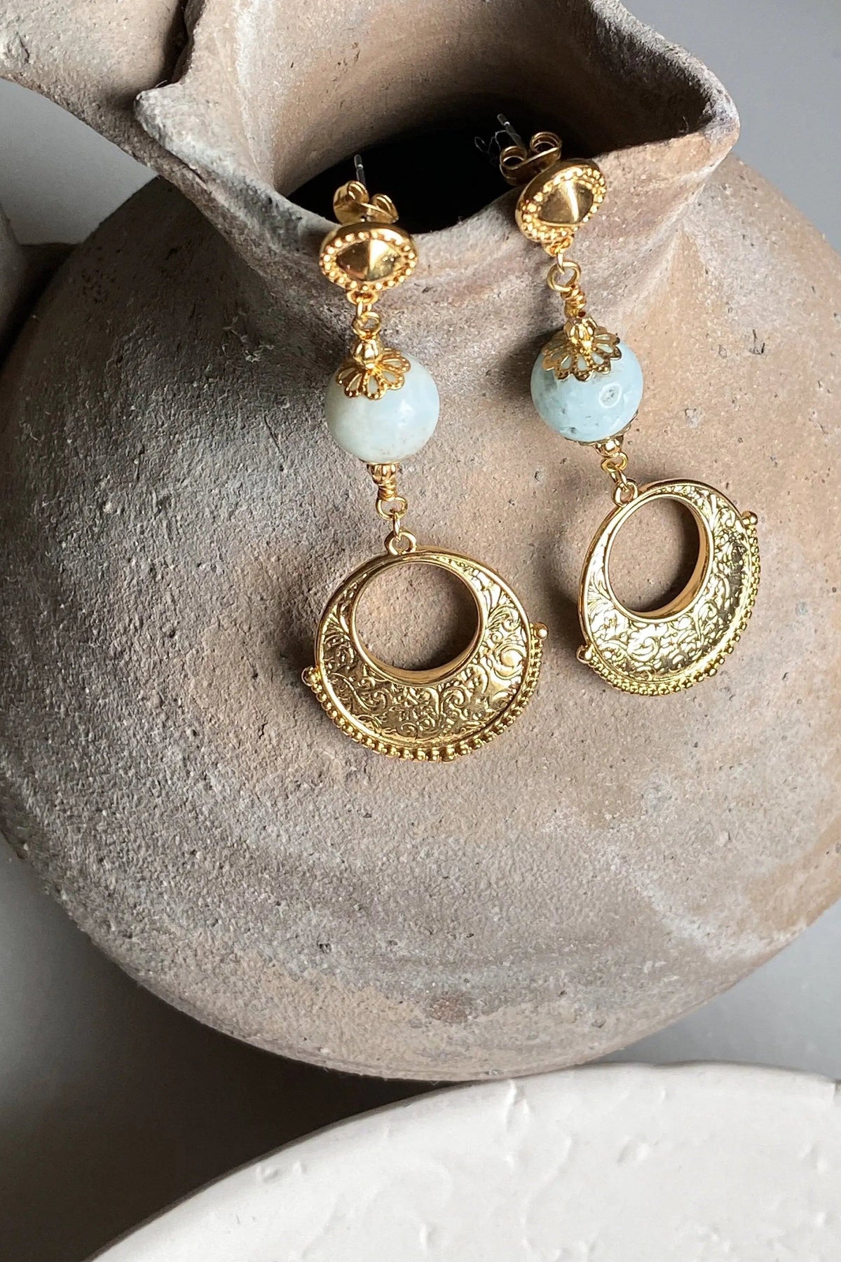Gypsy gold Earrings with ornate gold-tone filigree hoops, pale blue round beads and decorative stud tops