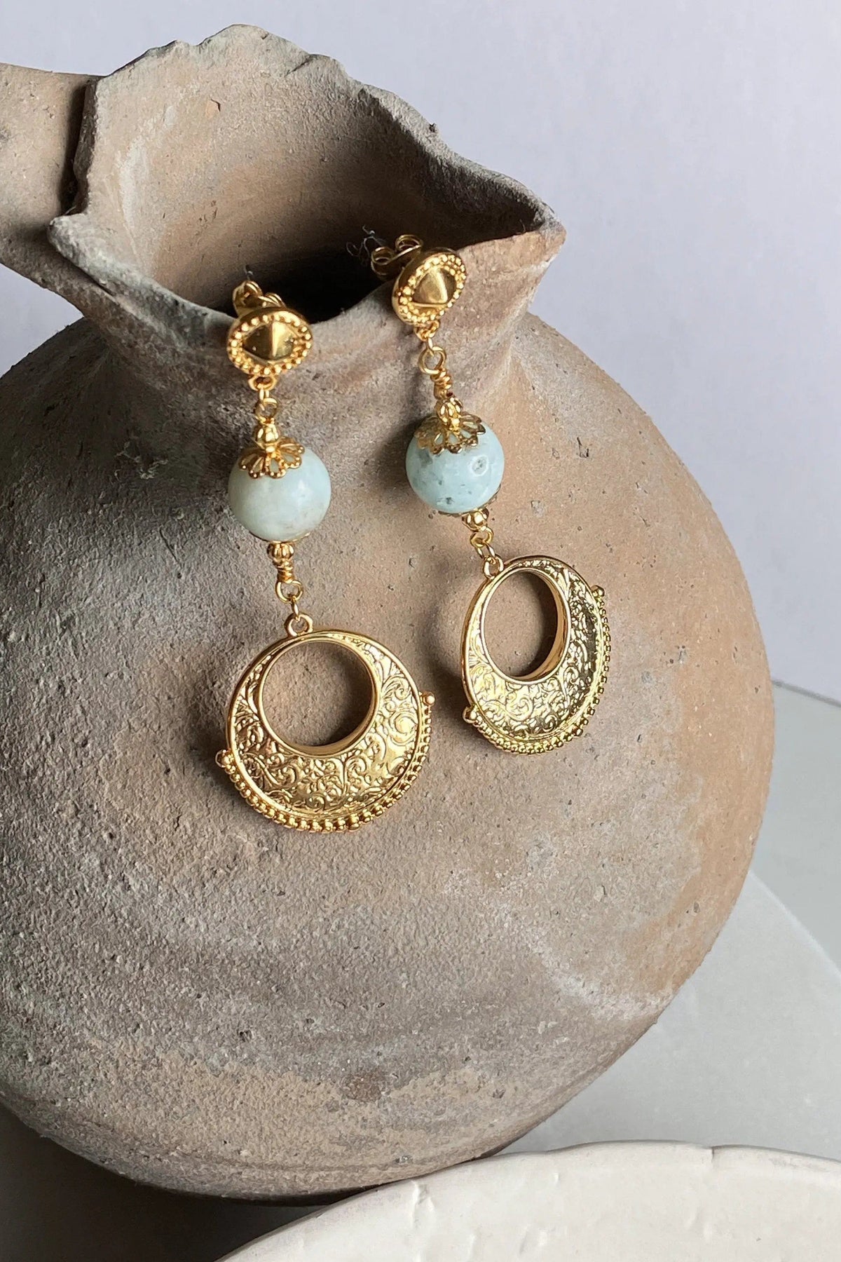 Gypsy gold Earrings with ornate gold-tone filigree hoops, pale blue beads, and decorative stud tops