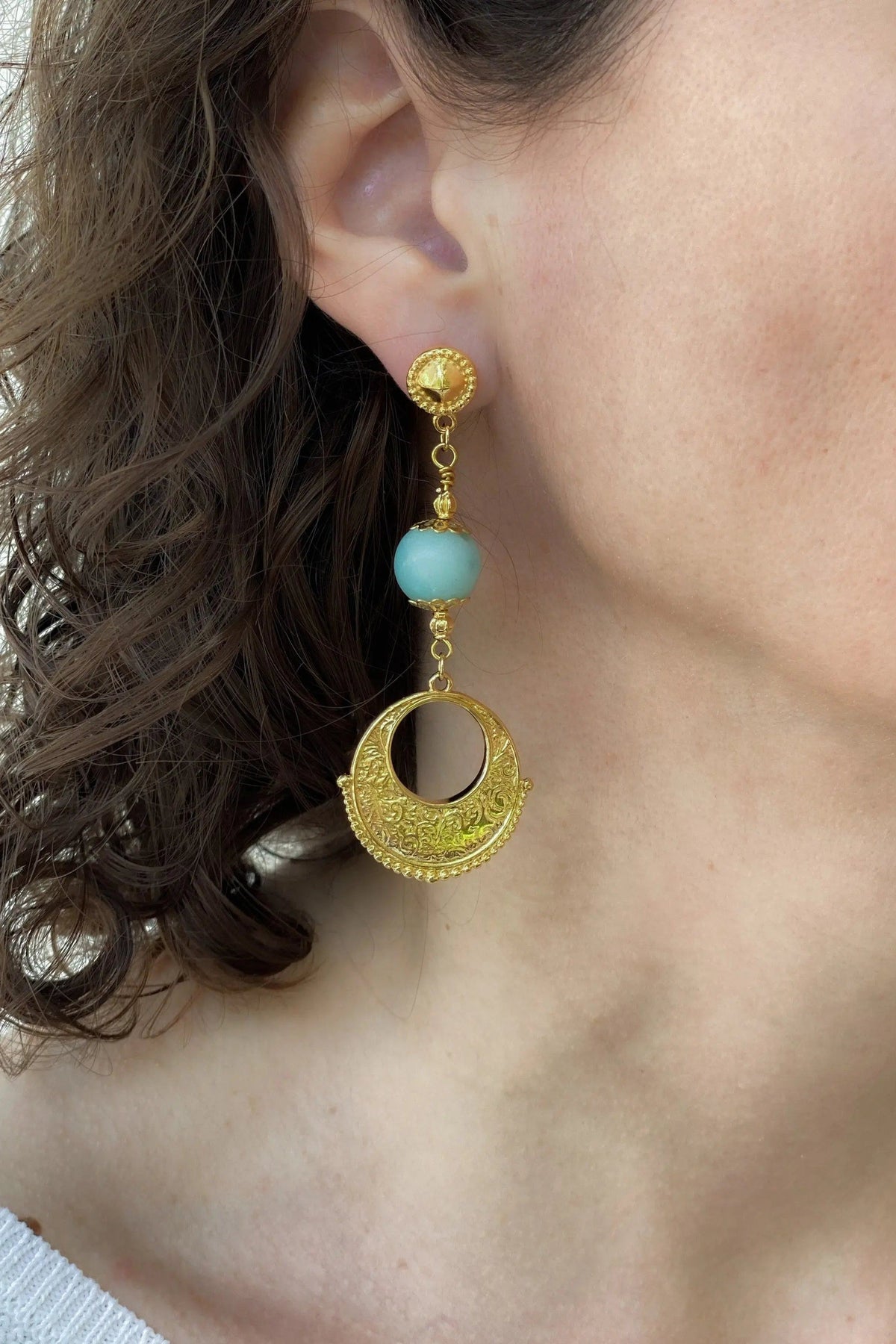 Gypsy gold Earrings featuring ornate gold-toned circular drops, delicate chain links, and a turquoise bead