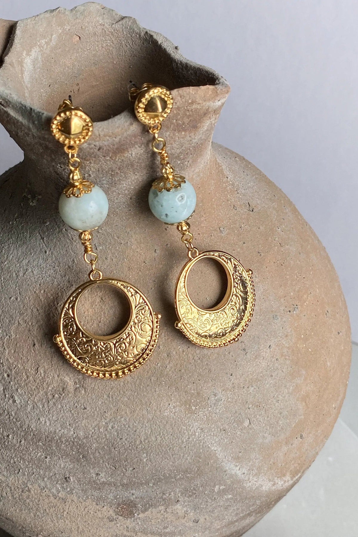 Gypsy gold Earrings with ornate gold-tone circular drops, pale blue beads, and intricate engraved crescent details