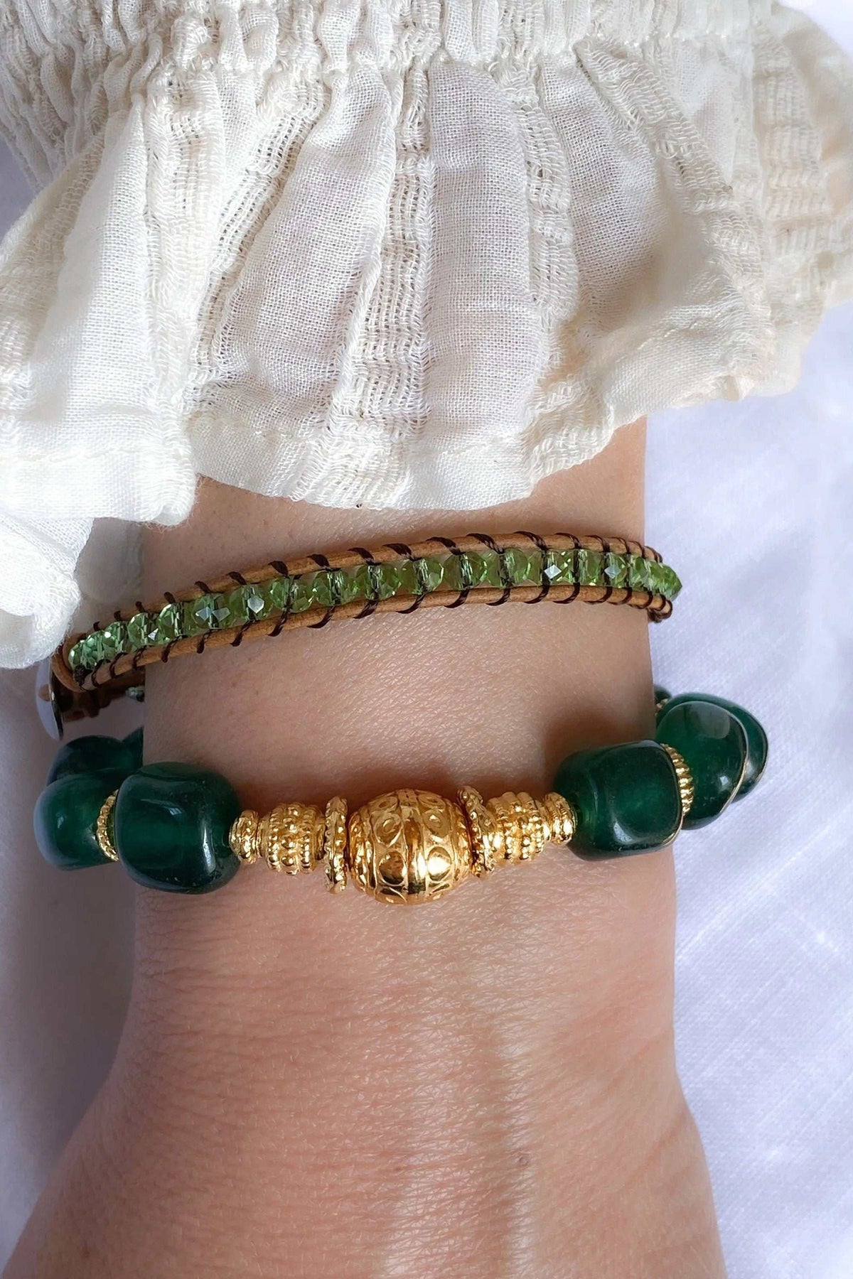Healing Crystal Bracelet with deep green jade beads and an ornate gold-tone central bead, paired with a slim green beaded bracelet