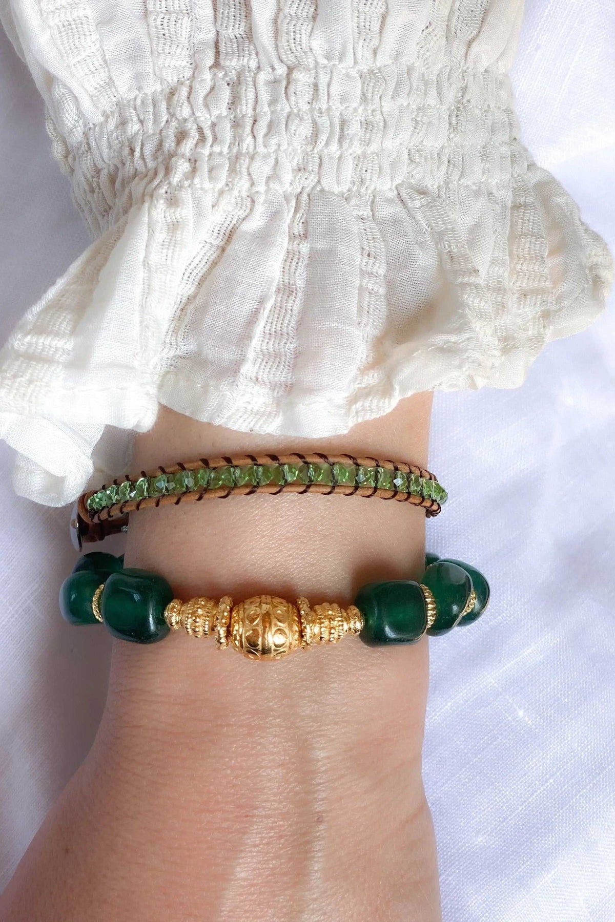Healing Crystal Bracelet with deep green jade beads, ornate gold-tone central bead and gold ethnic detailing