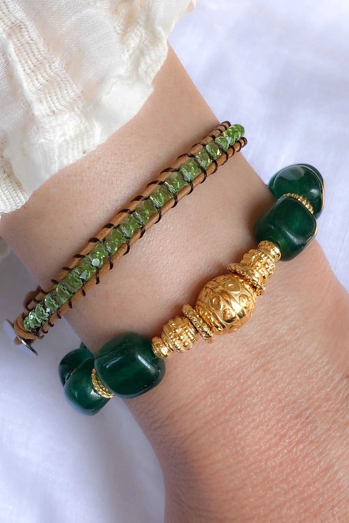 Healing Crystal Bracelet with glossy dark green jade beads, gold-toned ornate accents, and a slim strand of faceted green beads