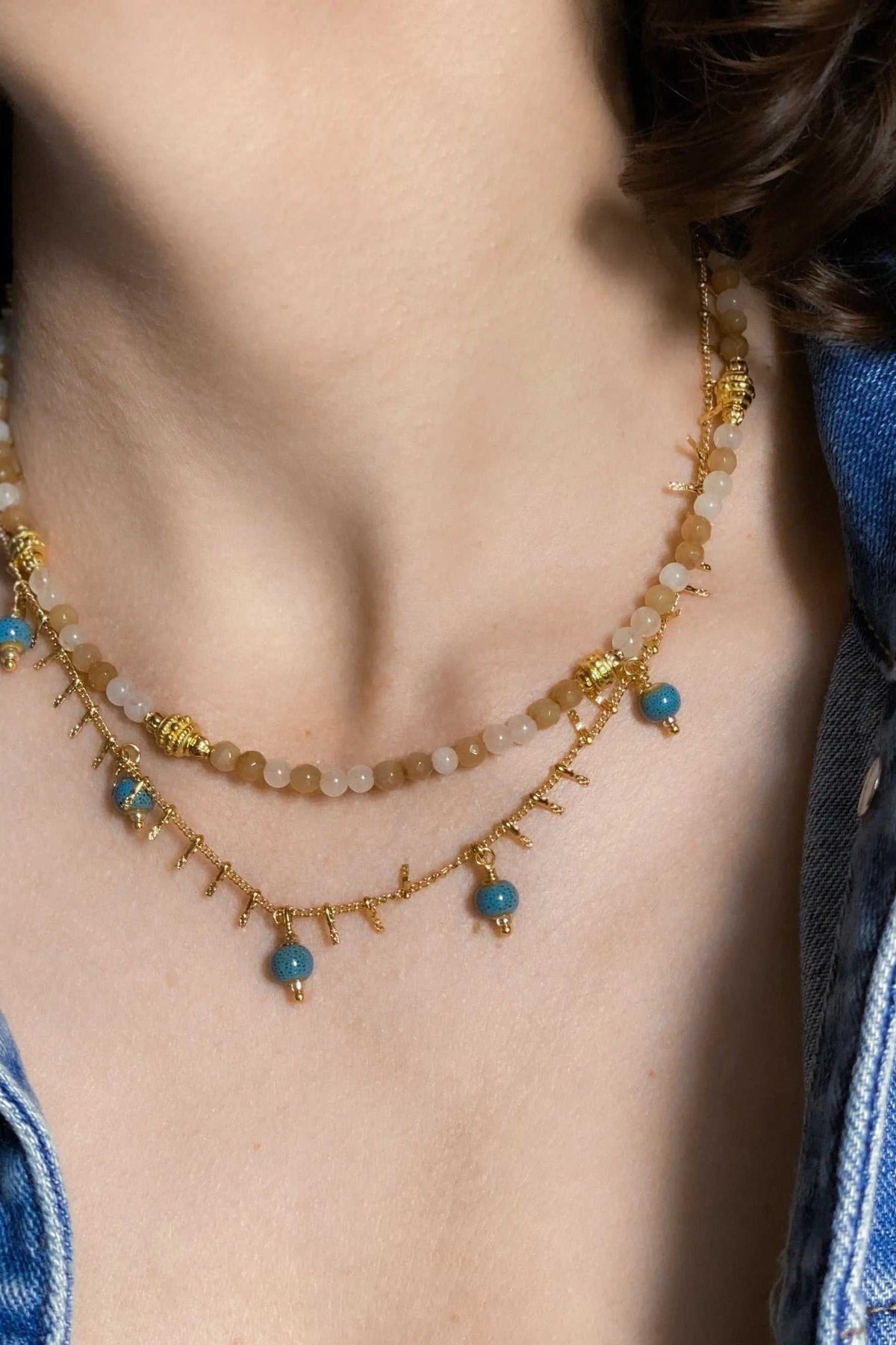 Heishi Bead Necklace in brown agate beads with gold accents, layered chains and blue bead charms