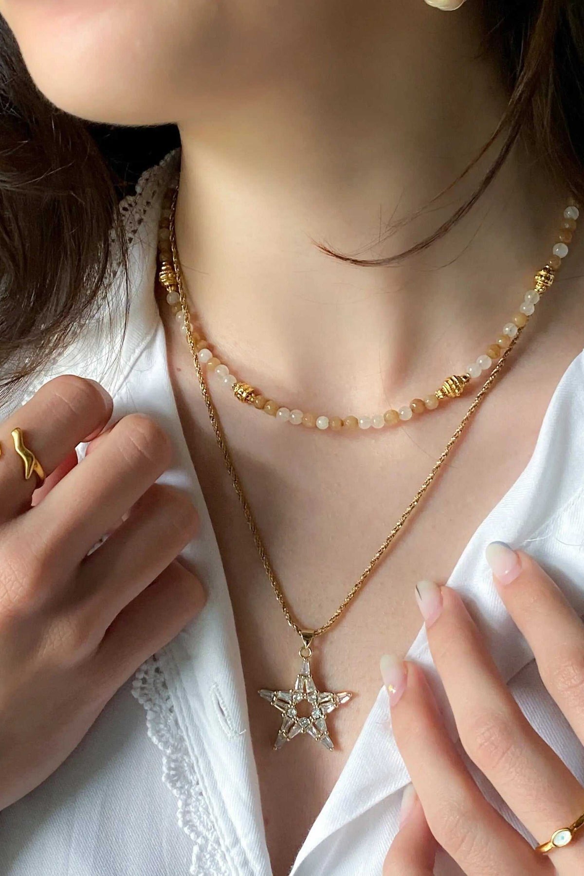 Heishi Bead Necklace in brown agate with gold accents and crystal beads, layered with a star pendant