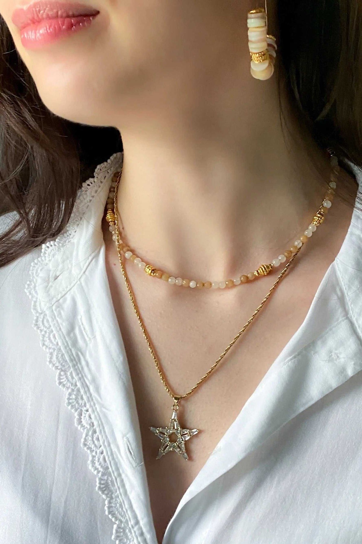 Heishi Bead Necklace with brown and cream beads, gold-toned accents, and delicate layered star pendant