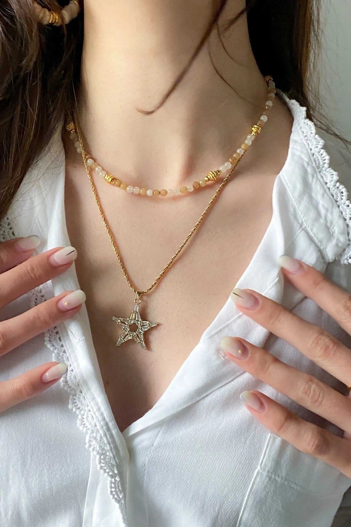 Heishi Bead Necklace with peach and cream beads, gold accents, and layered starfish pendant