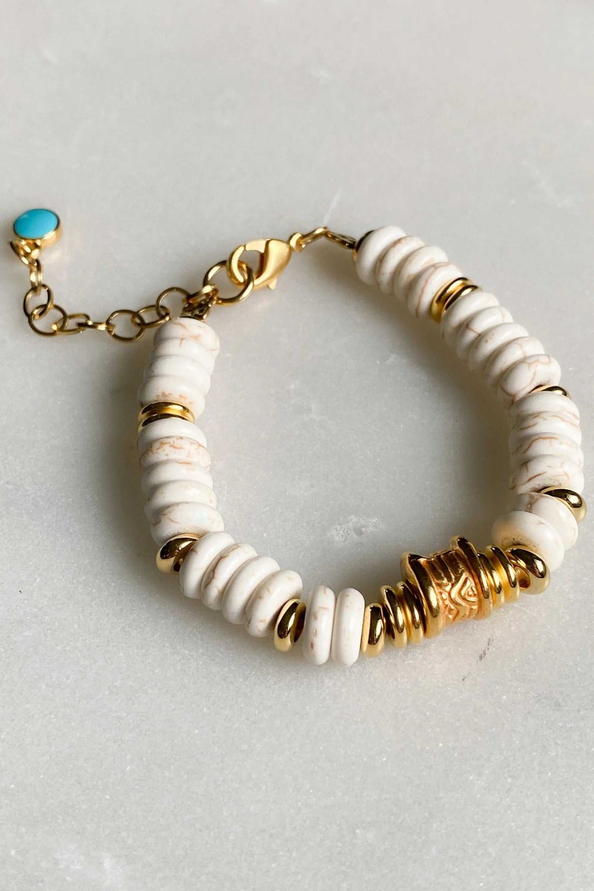 Heishi howlite beads bracelet with white ridged stone discs, gold-tone accents, lobster clasp and turquoise charm