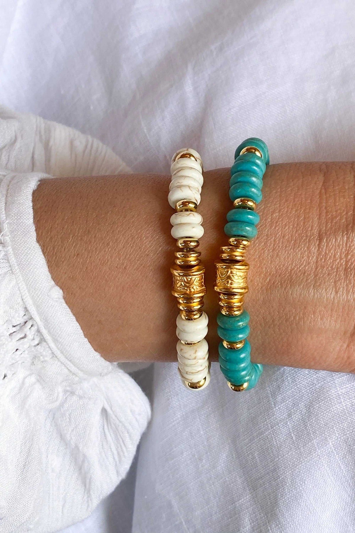 Heishi howlite beads bracelets in white and turquoise stone with gold-tone spacer beads and engraved central details