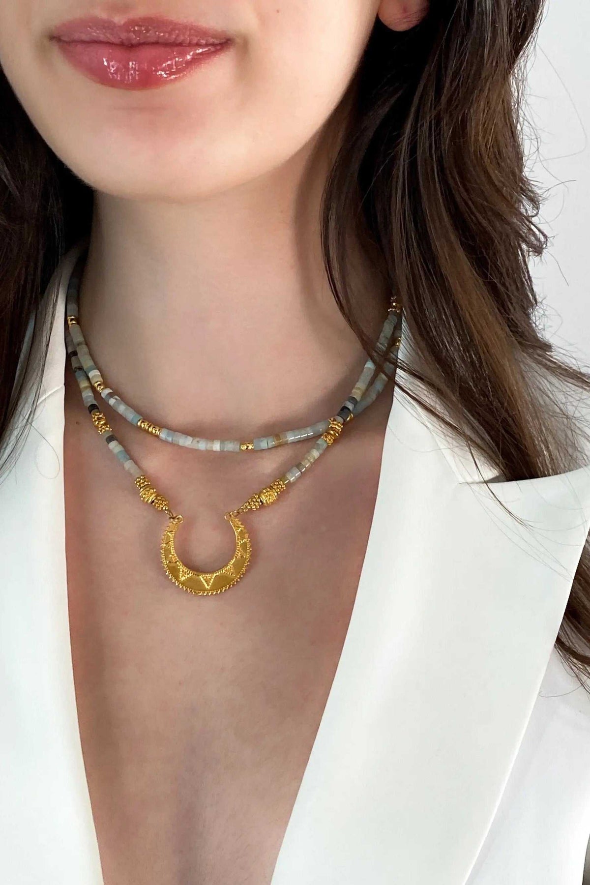 Heishi Necklace with blue-green amazonite beads, gold accents, and an ancient Greek motif pendant