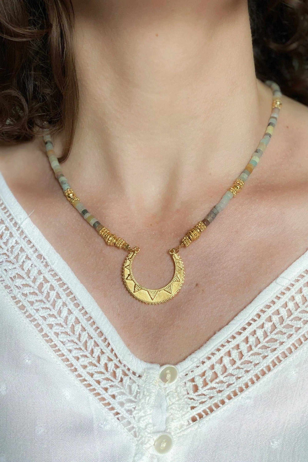Heishi Necklace with amazonite beads, gold accents, and a textured crescent Greek motif pendant