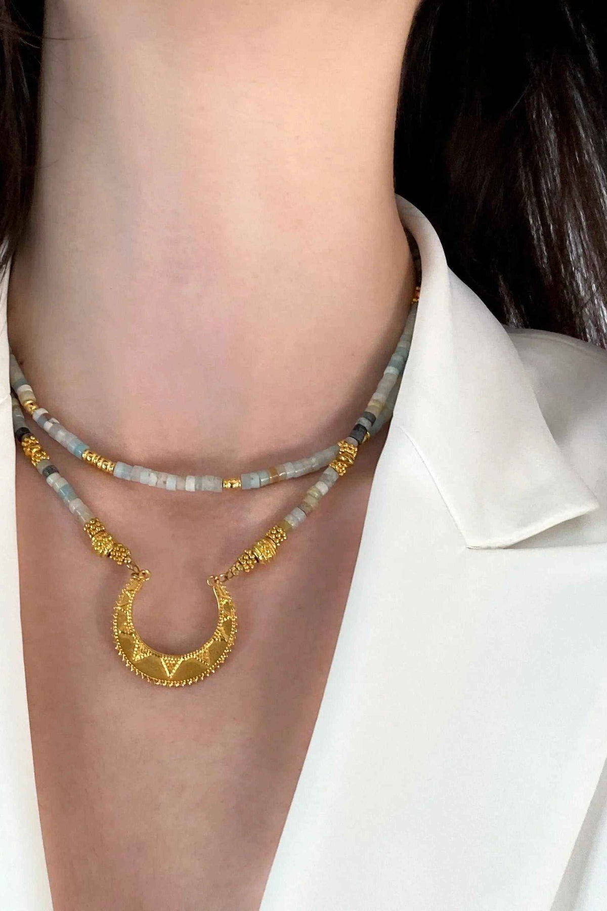Heishi Necklace with pale blue amazonite beads, gold accents, and a large textured gold pendant