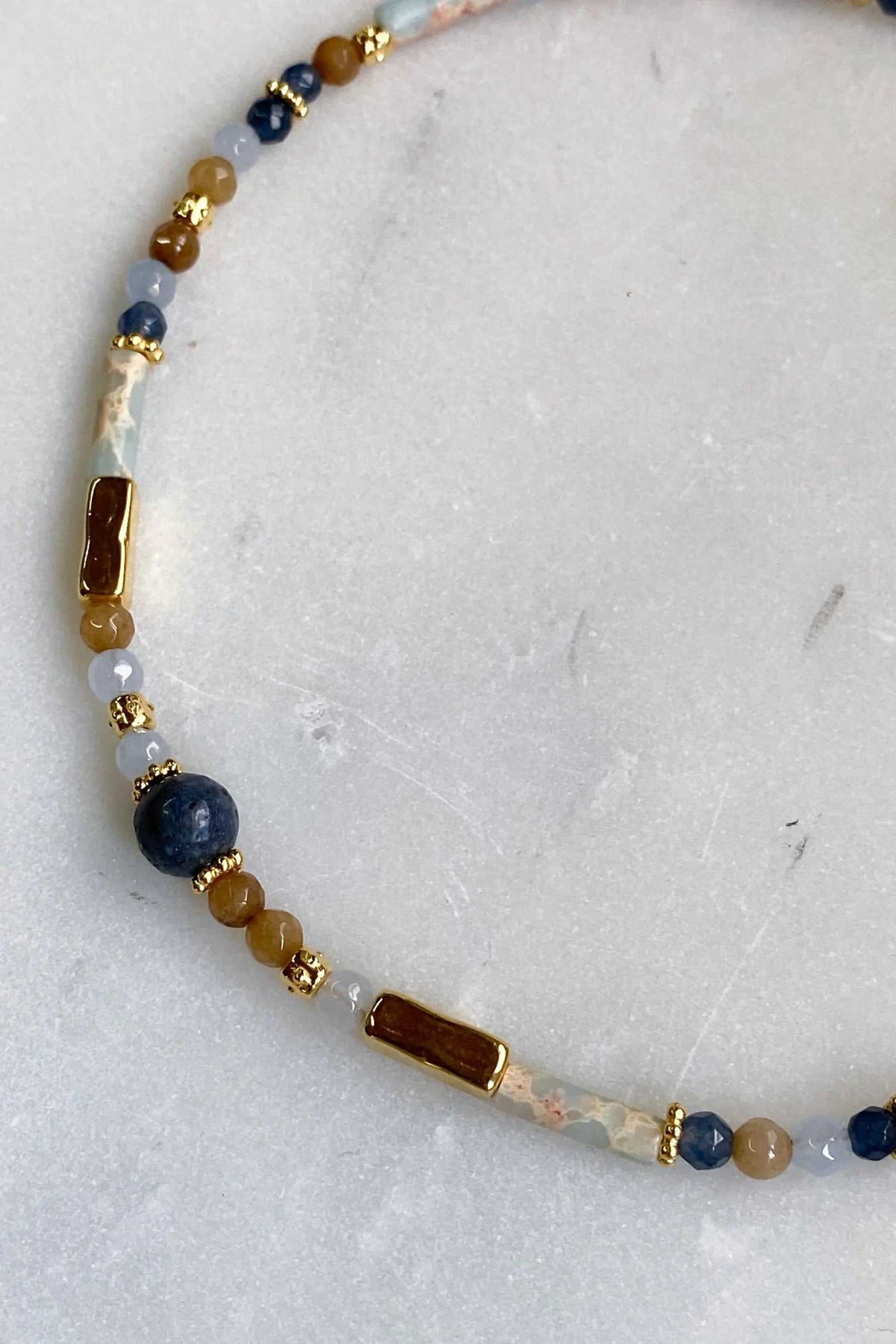 Heishi Necklace with blue and white beads, translucent stone accents, gold spacers and rectangular brown beads