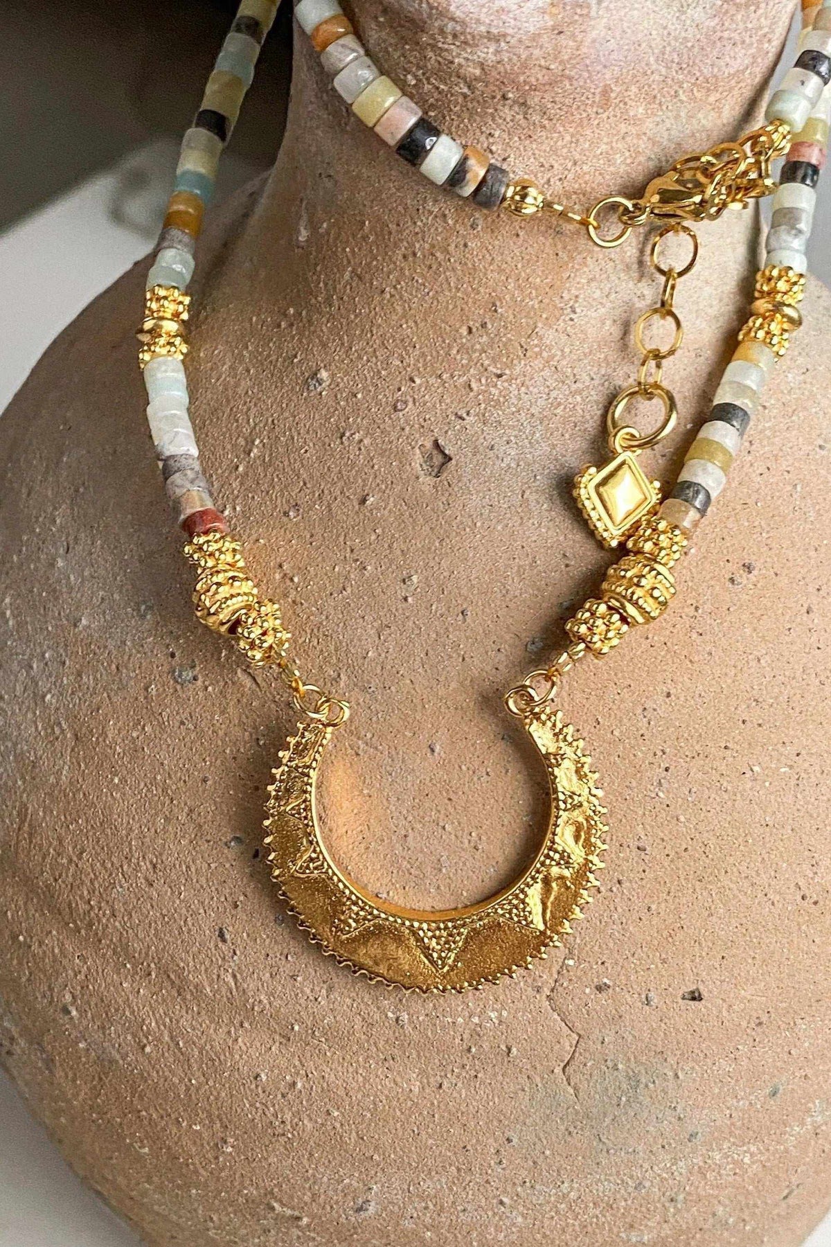 Heishi Necklace with multicolour beaded strands, gold accents, and ornate crescent-shaped pendant