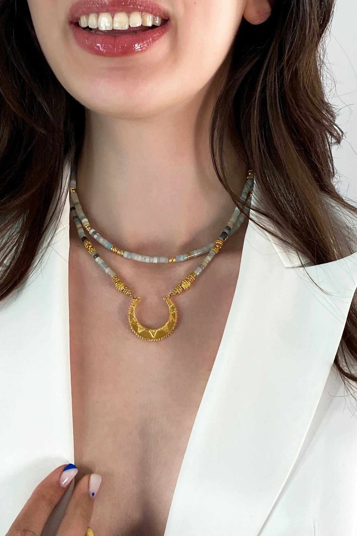 Heishi Necklace with pale blue and gold beads, layered design, and ornate gold circular pendant