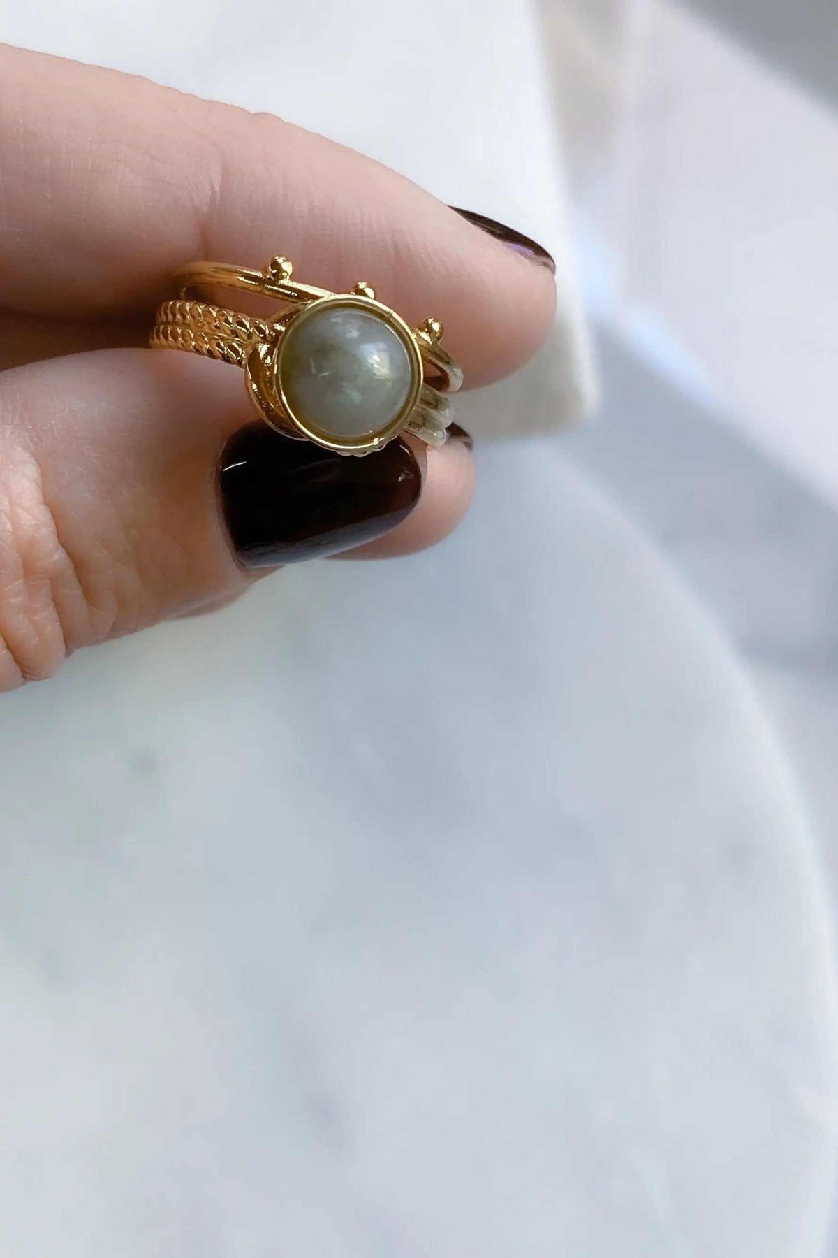 HERMINA Gold Stone Ring with a round grey labradorite cabochon in a gold-tone setting and textured band