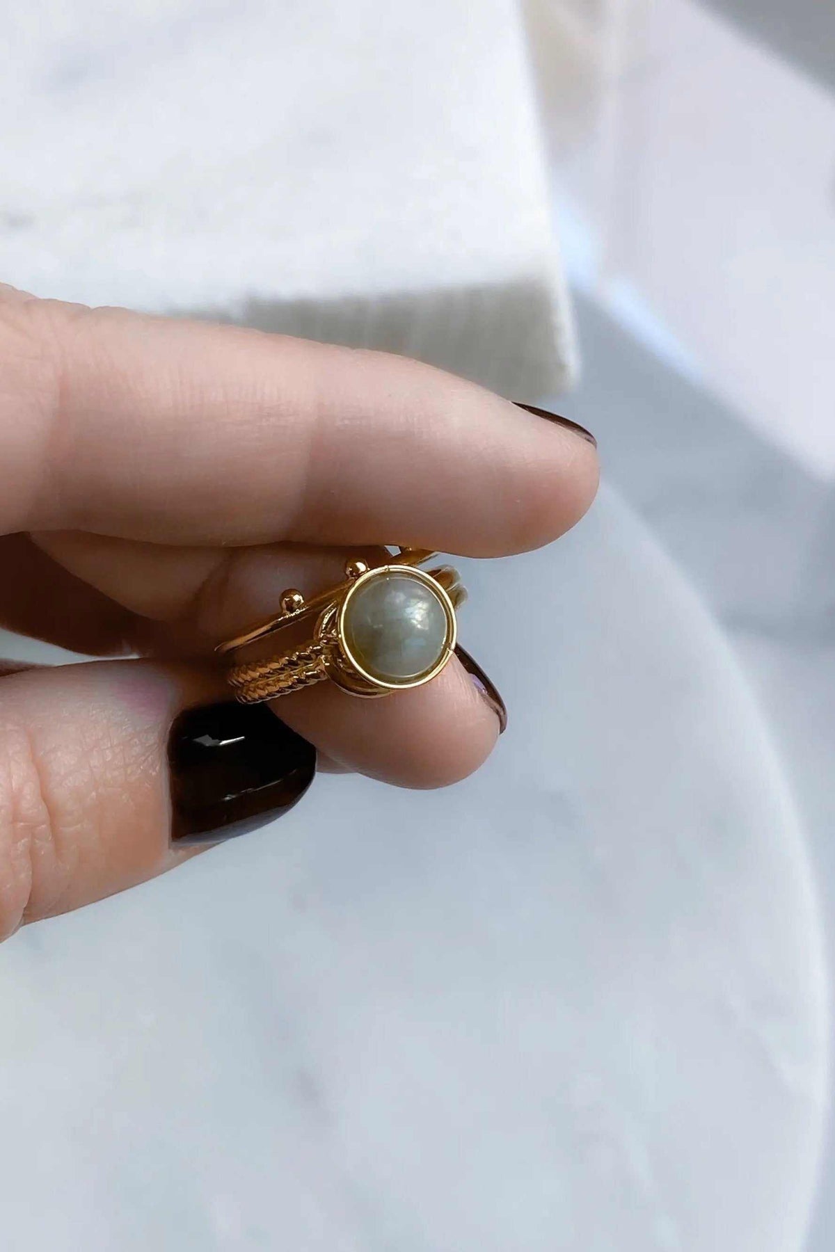 HERMINA Gold Stone Ring with a pale grey round stone in a gold-tone setting and a textured, adjustable band