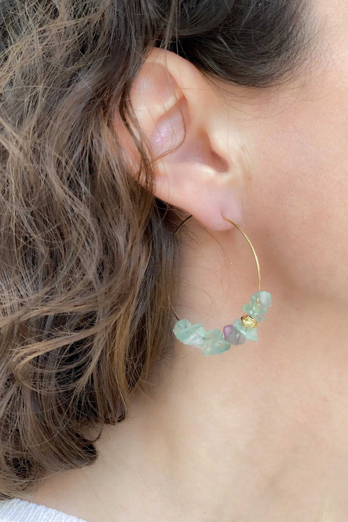 Hoop crystal earrings with slim gold-tone hoops and translucent pale aqua, blue-green and lavender chip stones