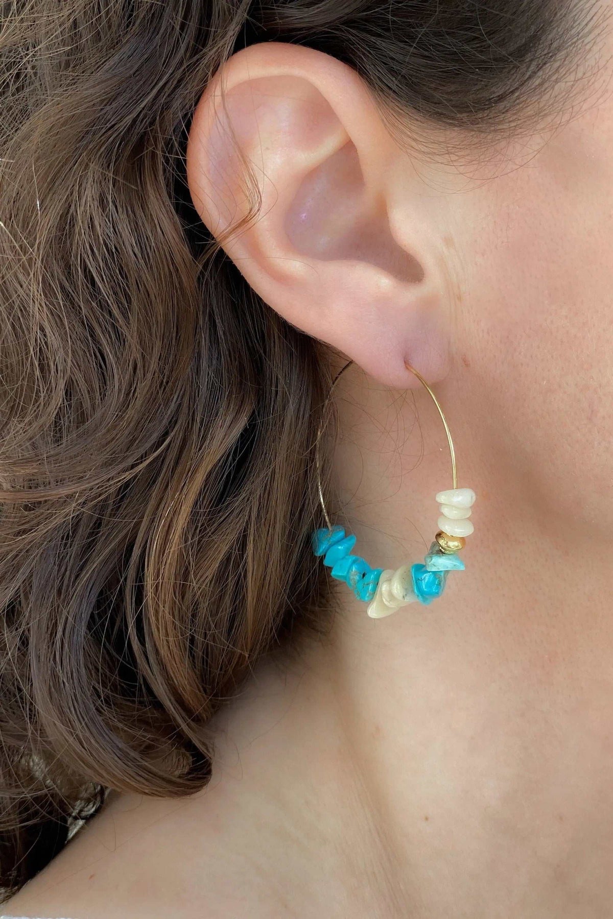 Hoop crystal earrings with a slender gold-tone wire hoop and turquoise blue and creamy white irregular stone beads