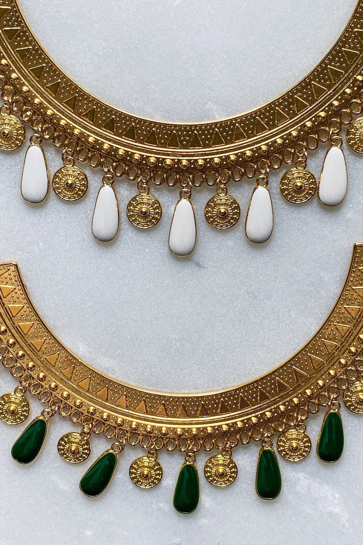 ILIADA NECKLACE with an ornate gold-tone engraved collar and dangling white and deep green teardrop charms