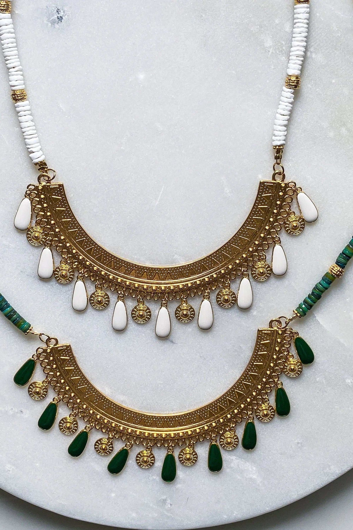 ILIADA NECKLACE shell bead design with ornate gold-tone ethnic pendants and white and green teardrop charms