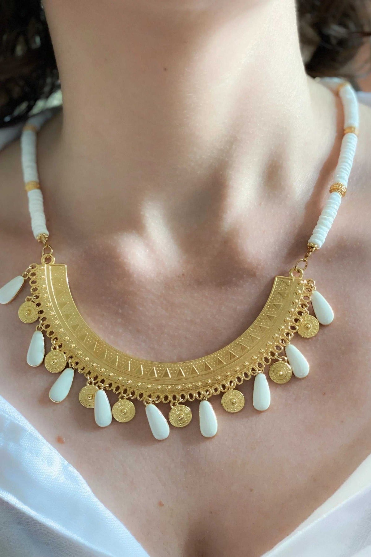 ILIADA NECKLACE, white shell bead necklace with ornate gold pendant and white enamel drop charms
