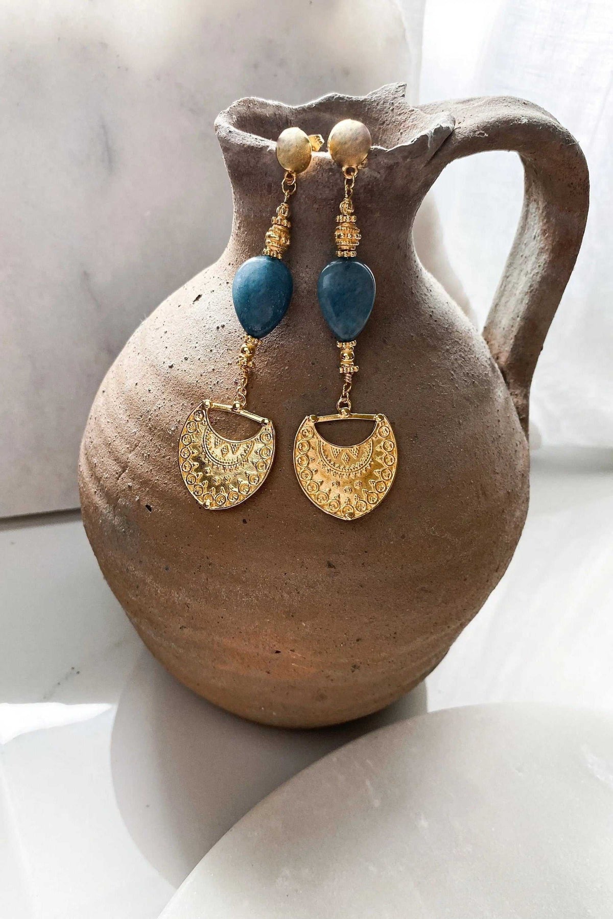 INÓ EARRINGS with gold-tone dangling chains, deep blue teardrop stones and ornate crescent-shaped gold-tone drops