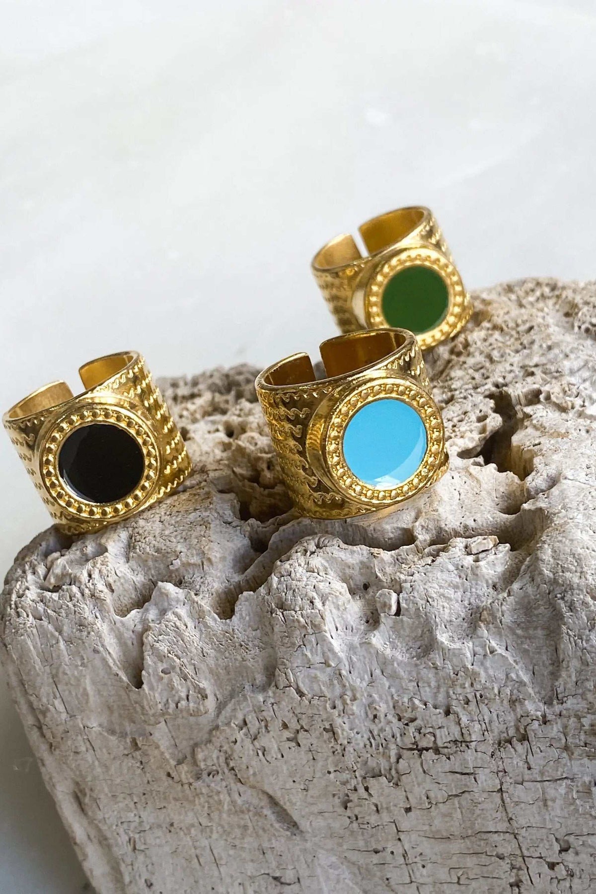 KARMI Gold wide band ring in textured gold-plated metal with round black, turquoise, and green resin stones
