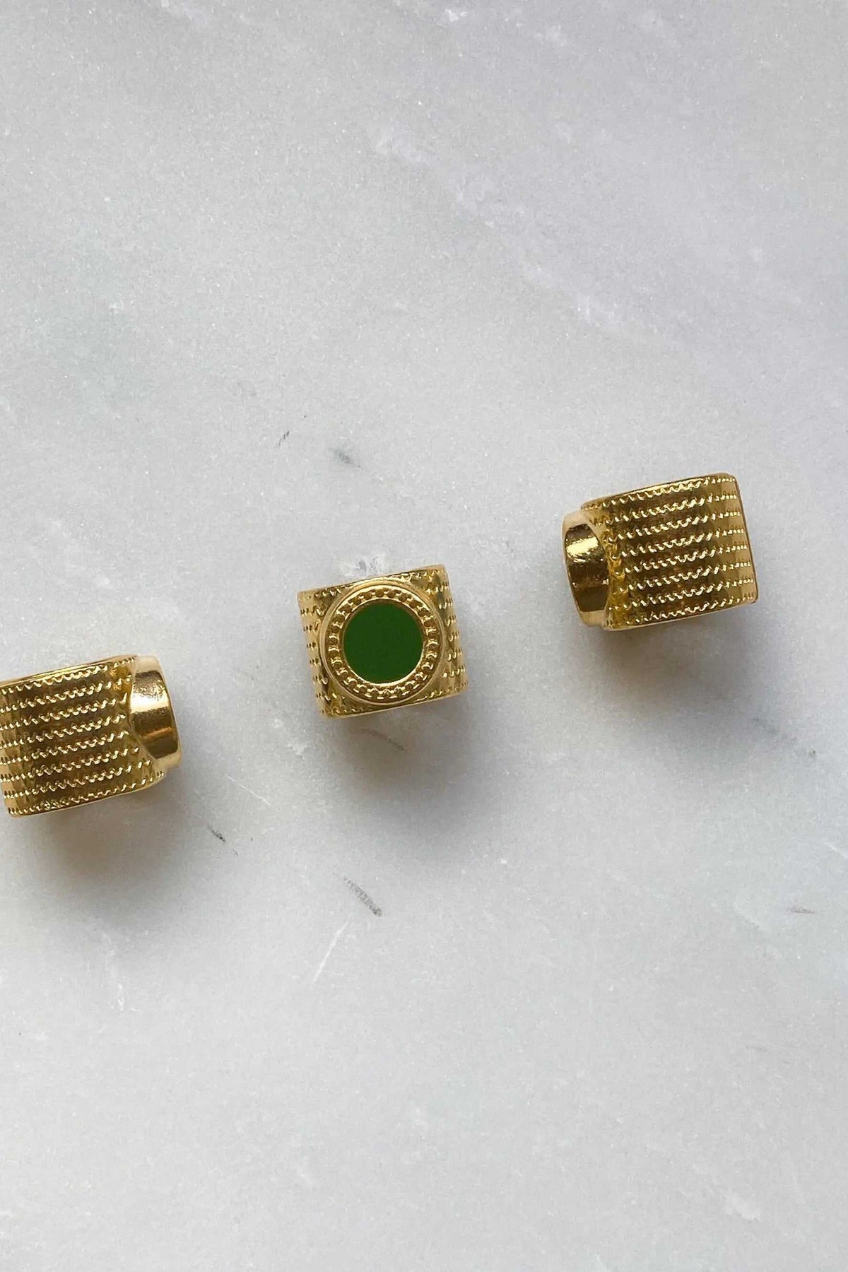 KARMI Gold wide band ring in textured gold with a round green resin stone and adjustable open band