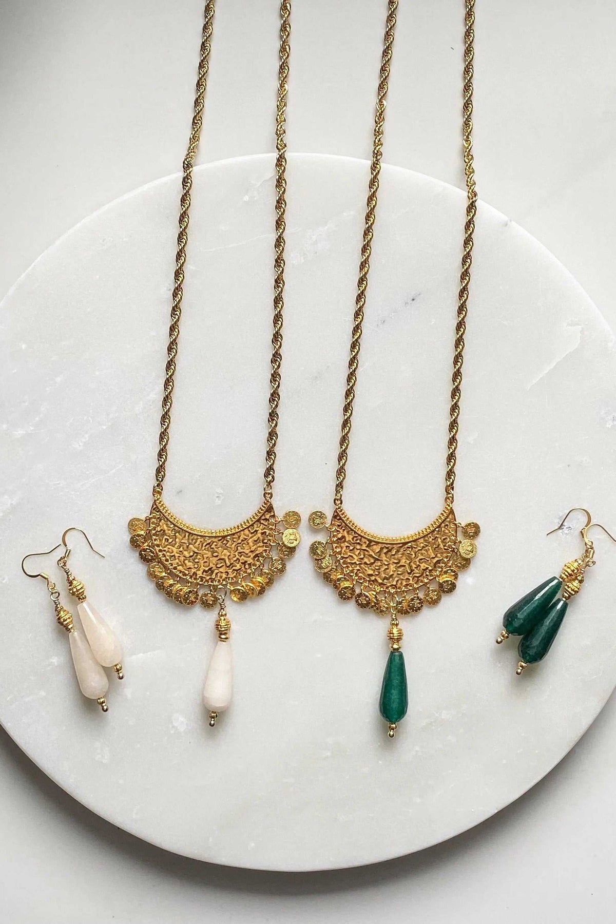 KIVÉLI Boho Necklace with gold-toned ornate pendants and white and green teardrop gemstone drops