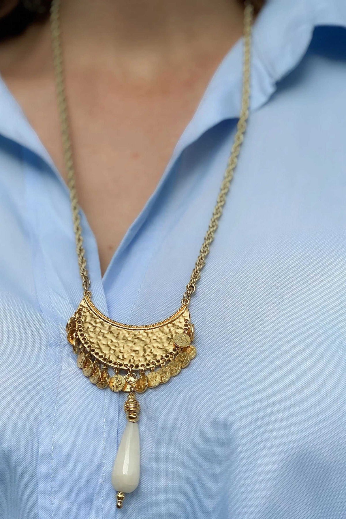 KIVÉLI Boho Necklace in gold-tone metal with textured layered pendants, coin details and a cream teardrop stone