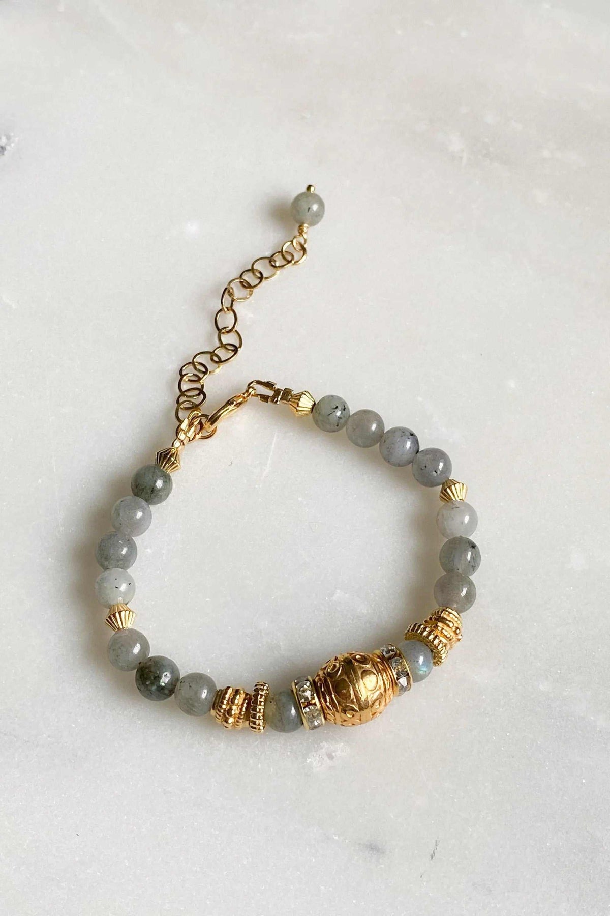 Labradorite beaded bracelet with translucent grey stone beads, ornate gold-tone accents and an adjustable chain clasp