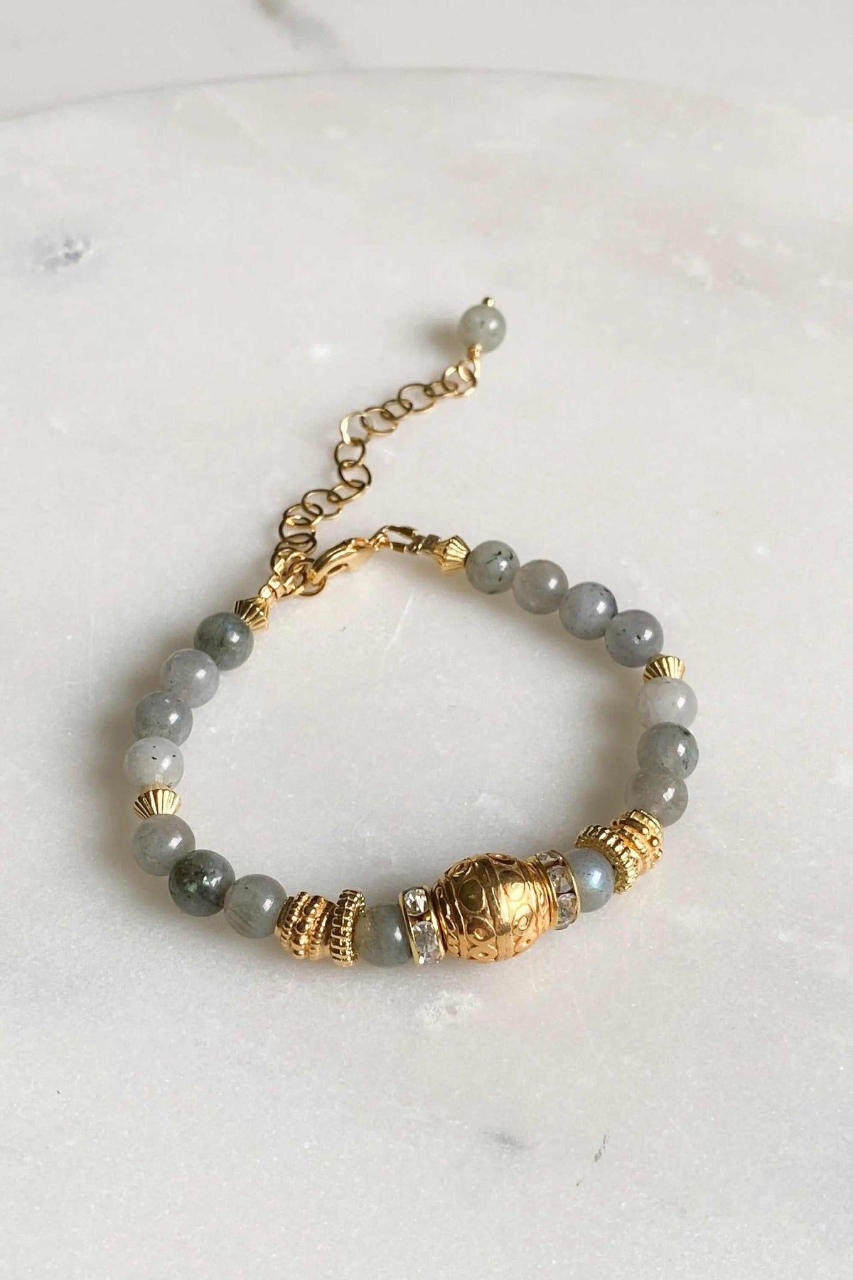 Labradorite beaded bracelet with grey round stones, gold-tone ethnic beads, a decorative centerpiece and extender chain