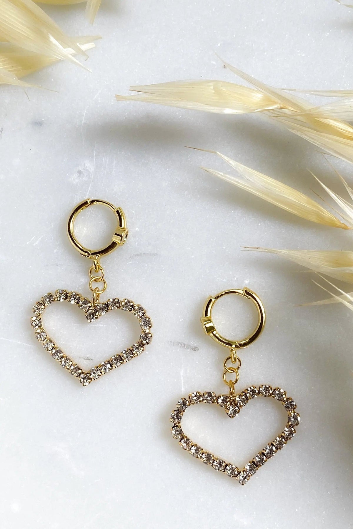 Large Heart Earrings with gold-tone huggie hoops and open heart charms edged in sparkling clear crystals