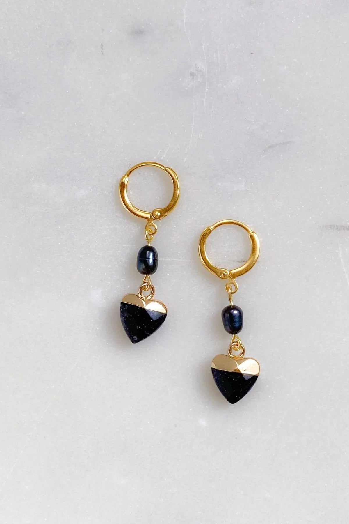 Little Heart dangle earrings in gold-tone metal with black heart charms and dark blue oval beads
