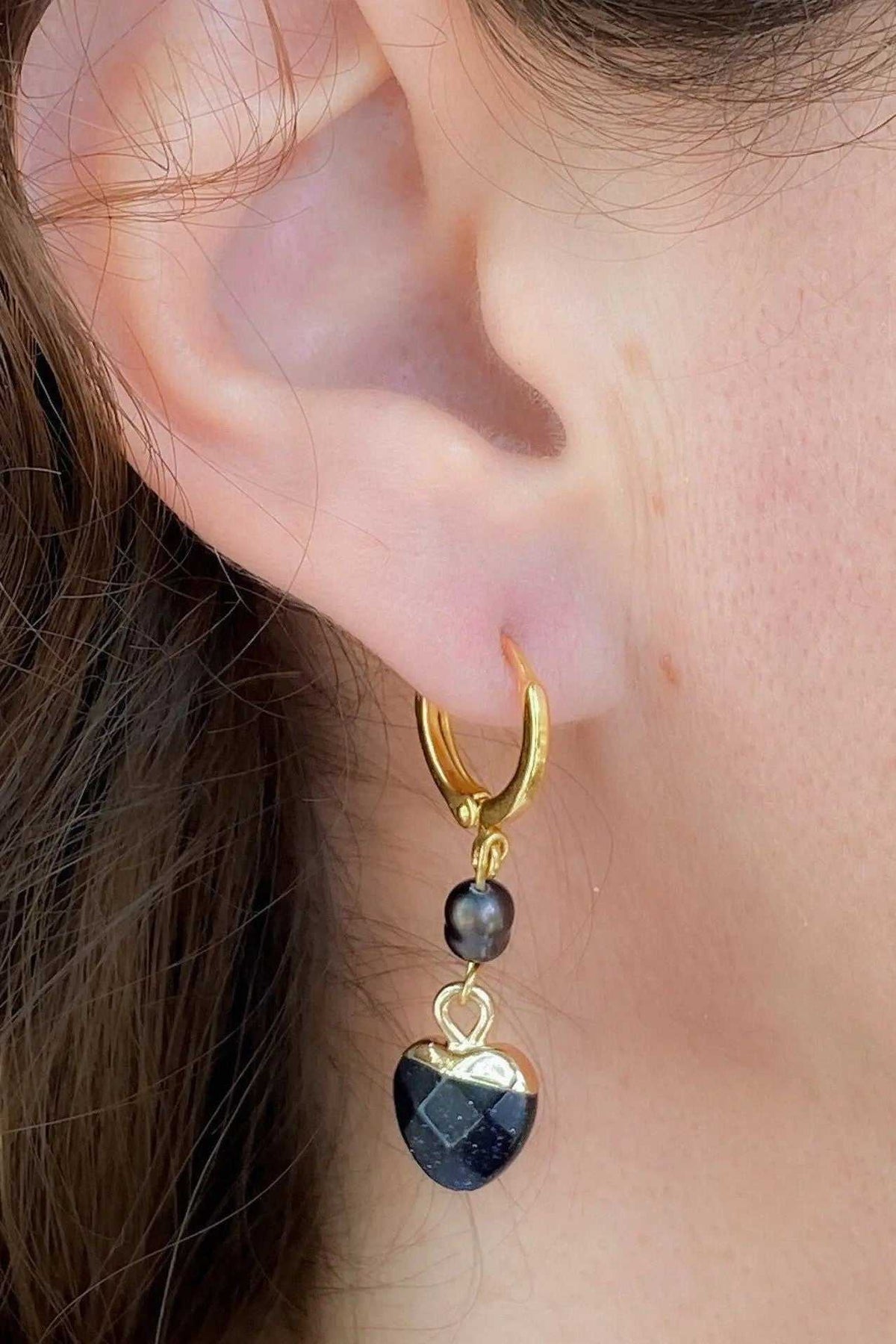 Little Heart dangle earrings with a dark blue faceted heart charm, black pearl, and gold-tone metal