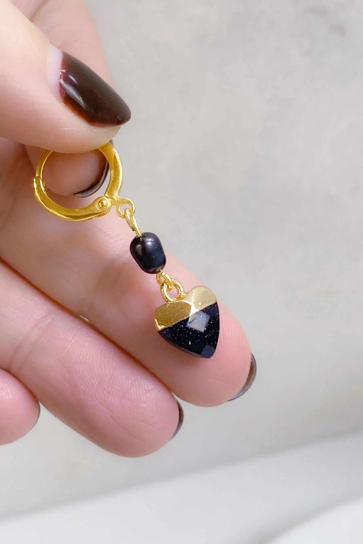 Little Heart dangle earrings in gold-tone metal with dark blue heart charms and dark pearl accents