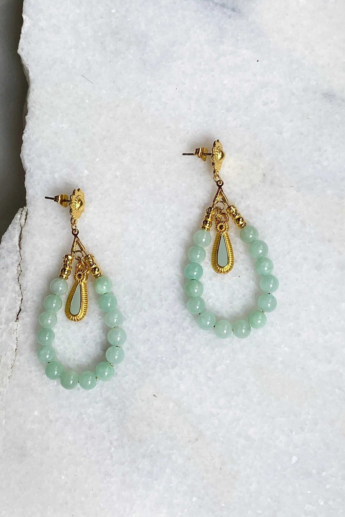 LUNO Oversize hoops earrings with pale green jade beads, gold-tone hoops, chains, and ornate drop details
