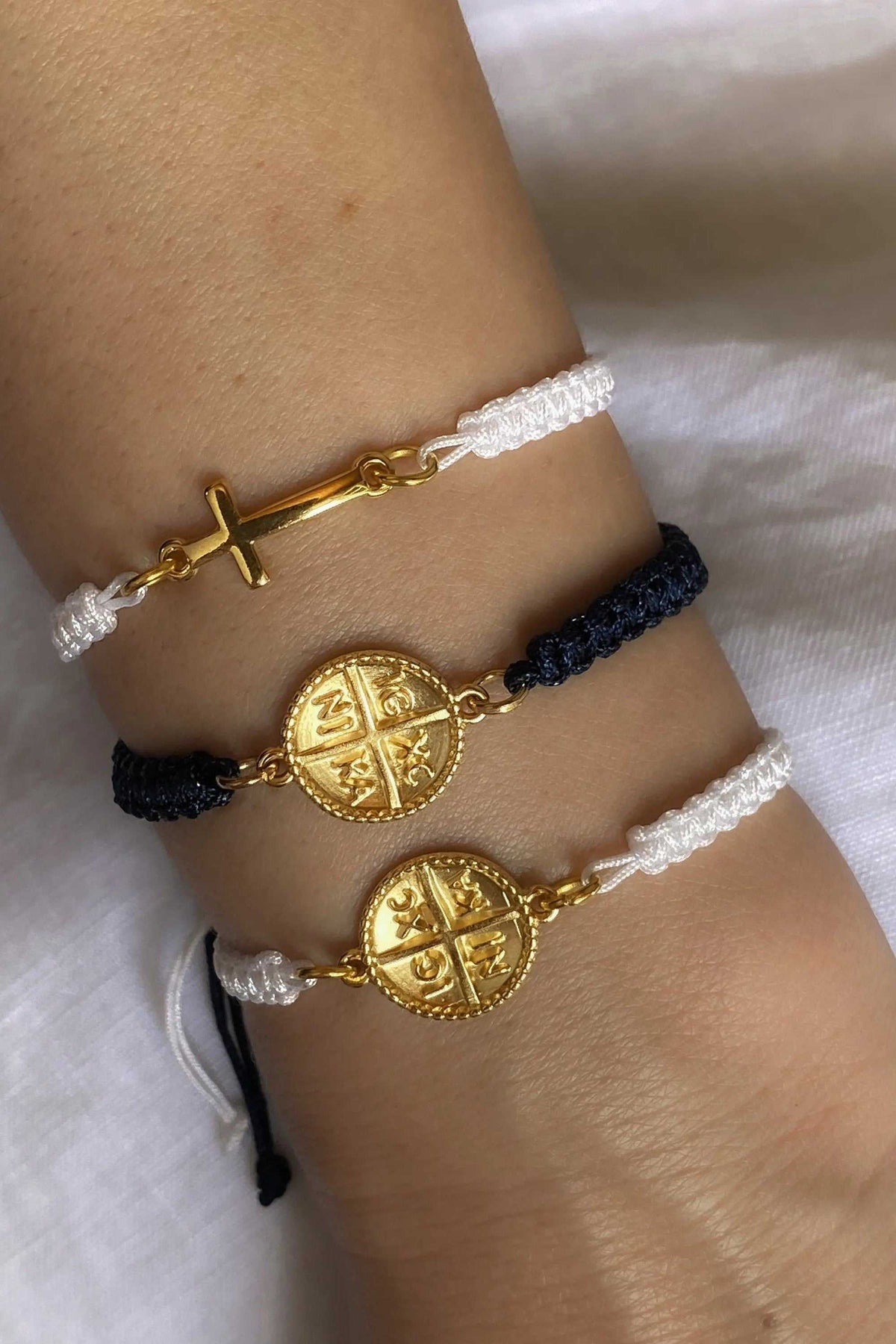 Macrame braided Bracelet with white and navy woven cords, gold-tone cross and Byzantine medallion charms