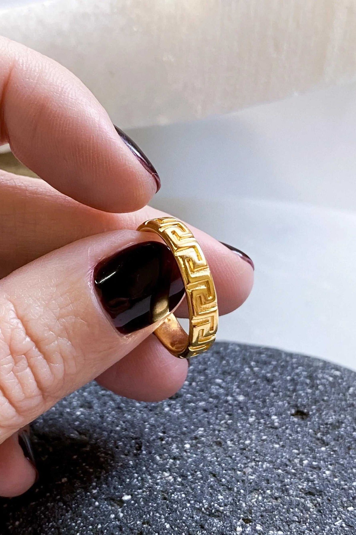 MEANDER Gold band Ring in polished gold-tone metal, featuring a raised geometric Greek meander pattern around the band.