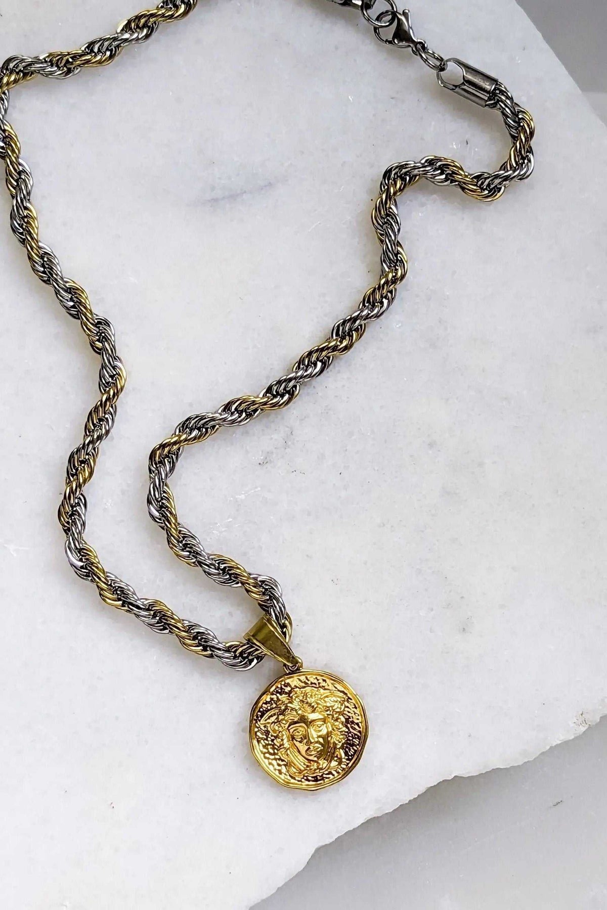 Medusa Chain Necklace with a twisted two-tone silver and gold rope chain and textured round gold Medusa coin pendant