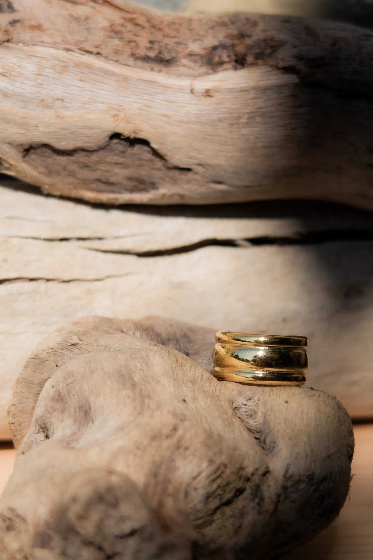 Minimal Boho Wide RING in polished gold-tone metal, featuring a broad band with layered curved ridges and an adjustable design