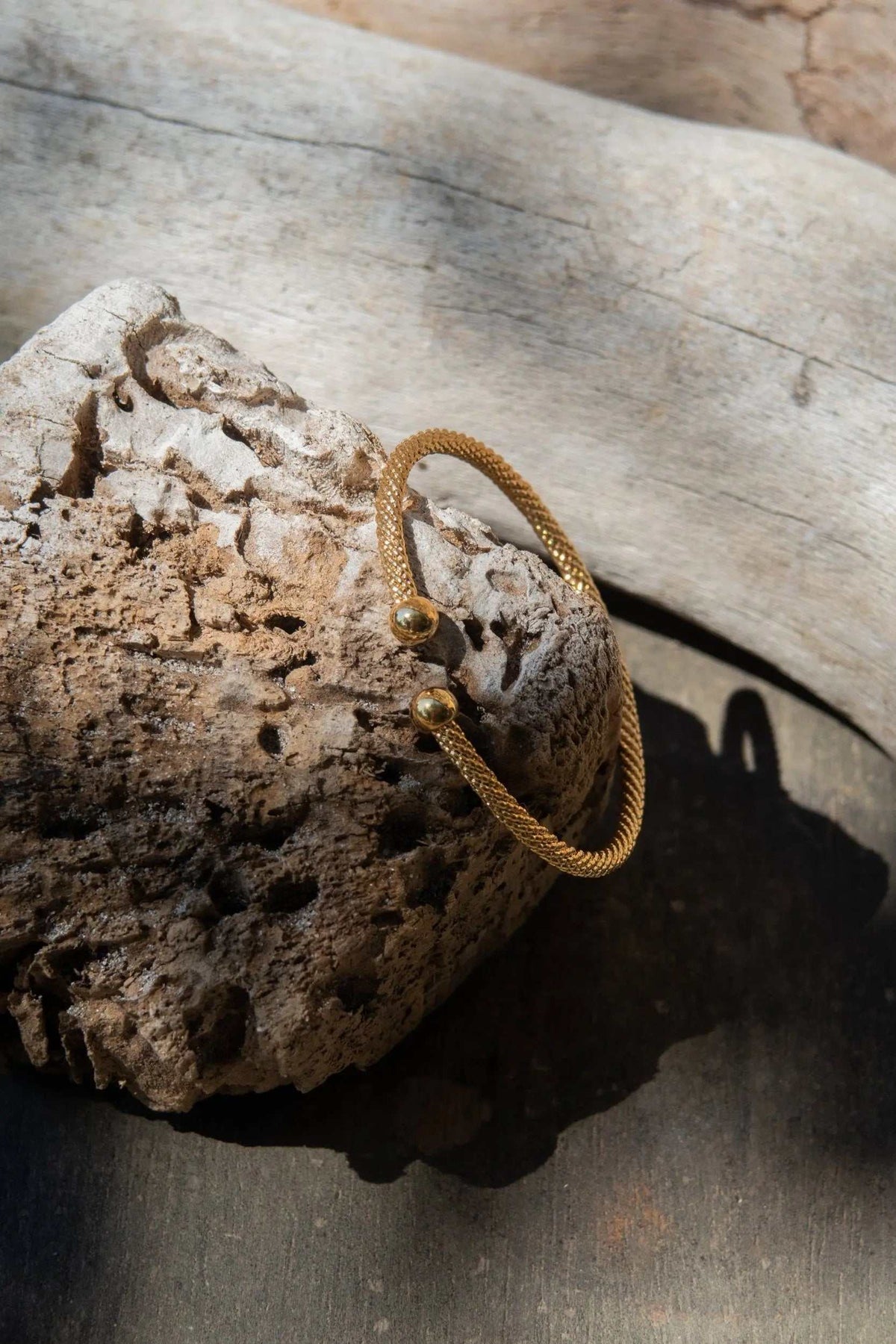 Minimal Twisted rope Bracelet in gold-tone twisted metal, with a slim adjustable rope band and rounded end caps