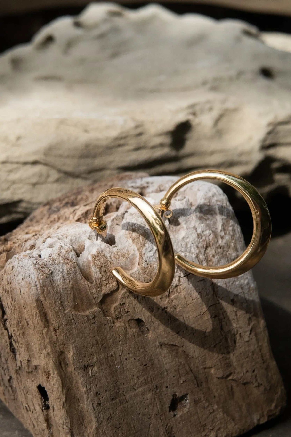 Minimalist 24k gold plated hoop earrings in smooth gold-tone metal with classic circular design