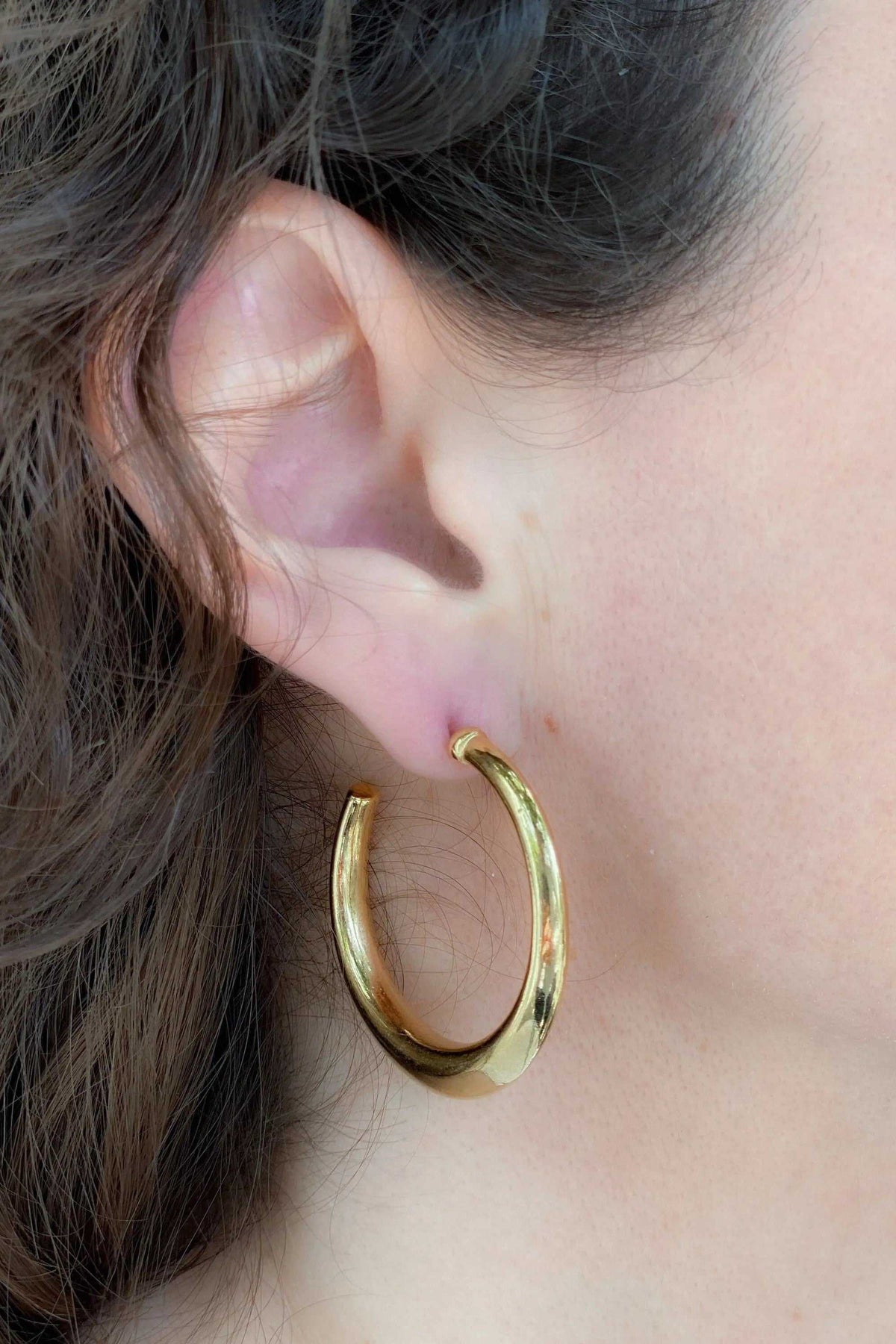 Minimalist 24k gold plated hoop earrings in polished gold-toned metal with a smooth, rounded design